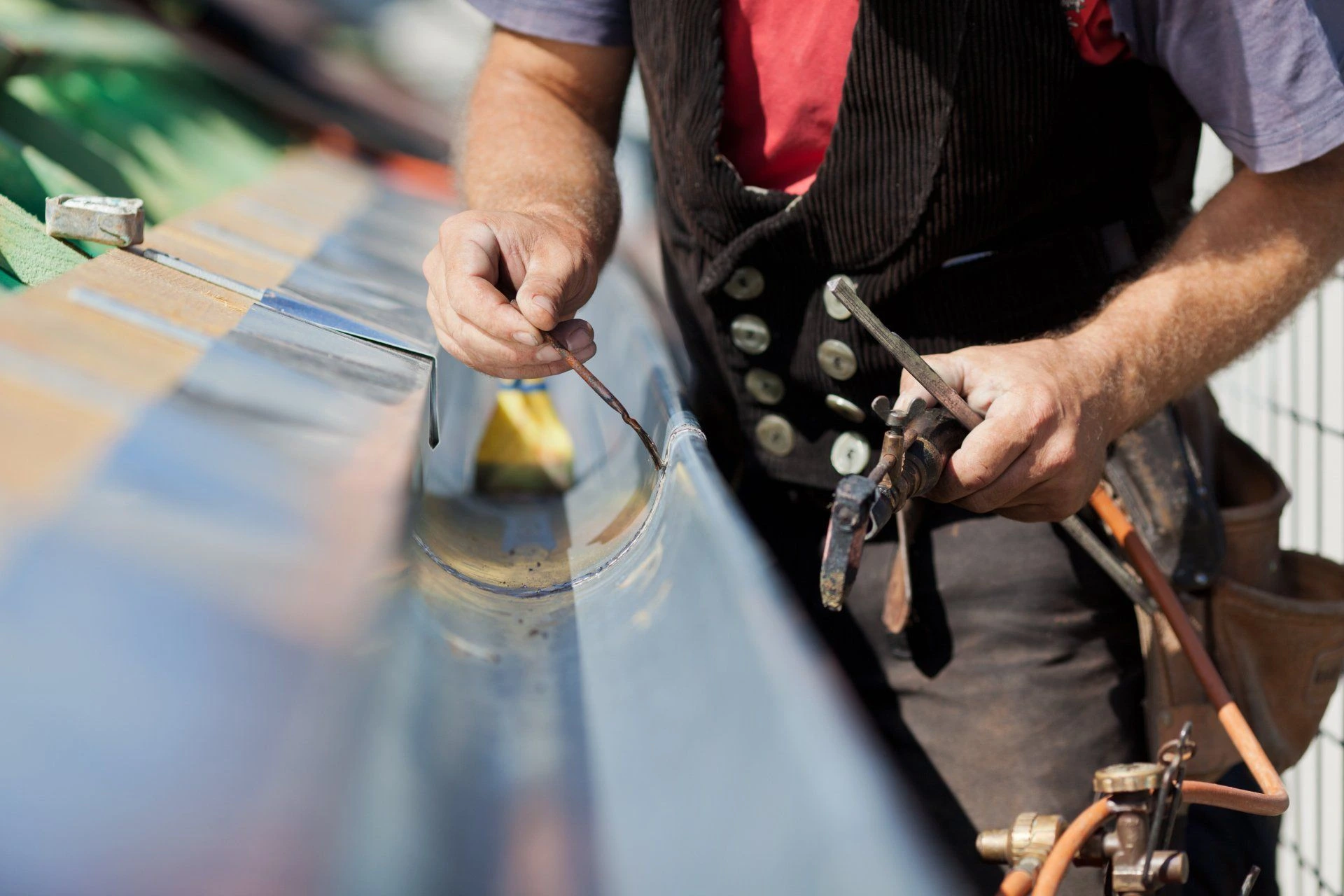 person working on gutter